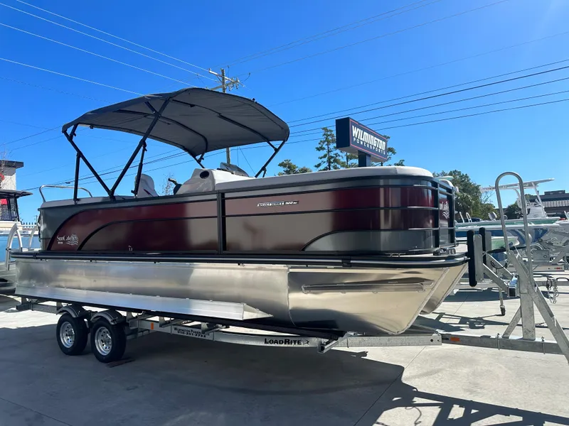 The Image of 2024 SunCatcher Select 322RC pontoon boat on a trailer at a dealership. - 0