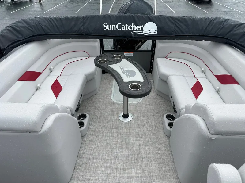 Slide: The Image of 2024 SunCatcher Select 322RC pontoon boat interior with plush seating and central table. - 10
