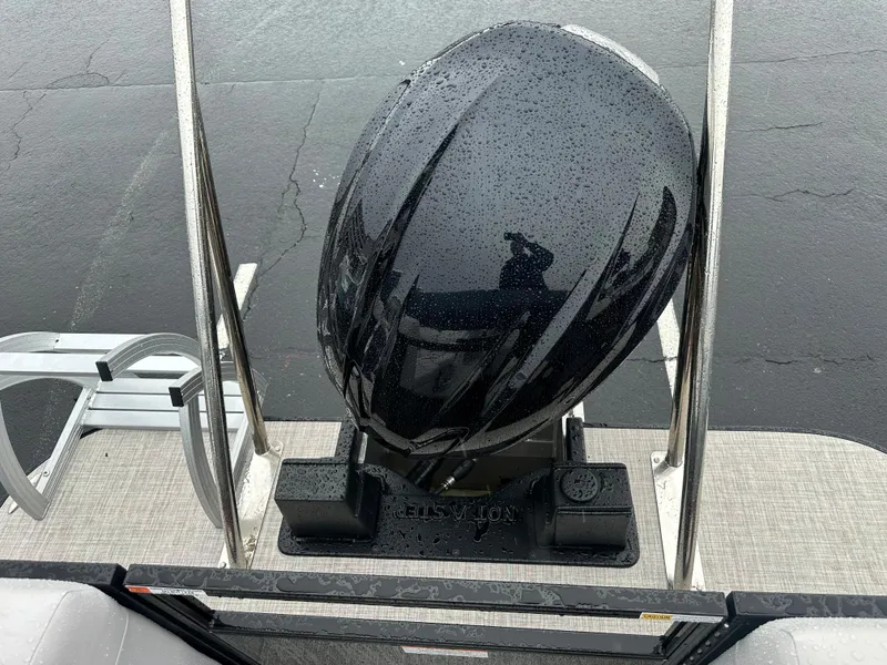 Slide: The Image of 2024 SunCatcher Select 322RC boat with a black outboard motor in the rain. - 11