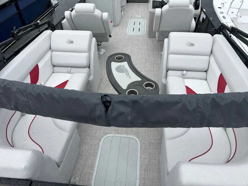 Slide: The Image of 2024 SunCatcher Select 322RC boat interior with plush seating and central table. - 12