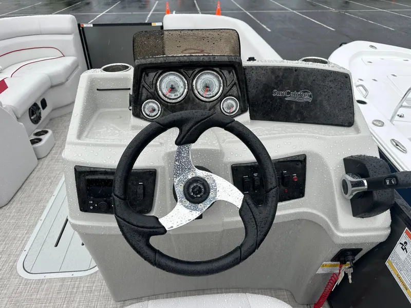 Slide: The Image of 2024 SunCatcher Select 322RC boat dashboard with steering wheel and instrument panel. - 15