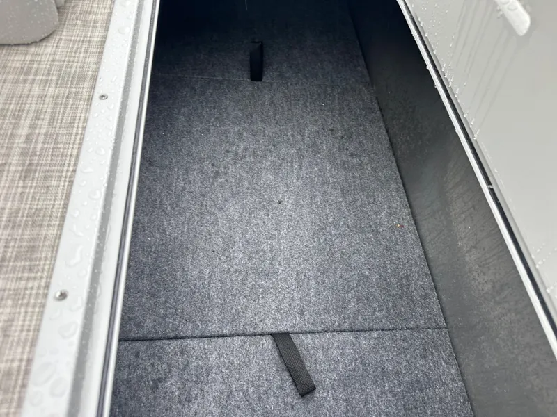 Slide: The Image of 2024 SunCatcher Select 322RC storage compartment with carpeted interior. - 19