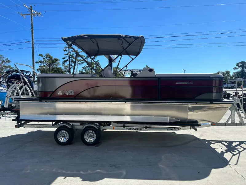 Slide: The Image of 2024 SunCatcher Select 322RC pontoon boat on a trailer, side view. - 20