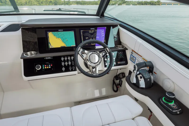Slide: The Image of 2024 Sea Ray Sundancer 320 Outboard helm with advanced navigation displays and controls. - 16