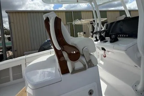Slide: The Image of Jupiter 30 boat interior, featuring a modern helm seat and control panel, 2025 model. - 10