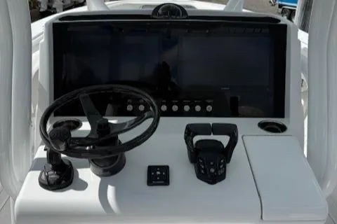 Slide: The Image of Control panel of a 2025 Jupiter 30 boat with steering wheel and digital displays. - 11