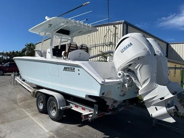 Slide: The Image of 2025 Jupiter 30 boat on trailer with Yamaha engines, parked outdoors. - 3