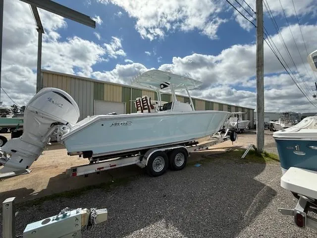 Slide: The Image of 2025 Jupiter 30 boat on trailer, parked outdoors under cloudy sky. - 4