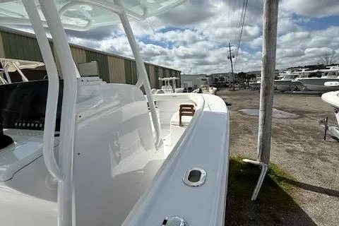 Slide: The Image of 2025 Jupiter 30 boat docked, showcasing sleek white design under cloudy sky. - 9