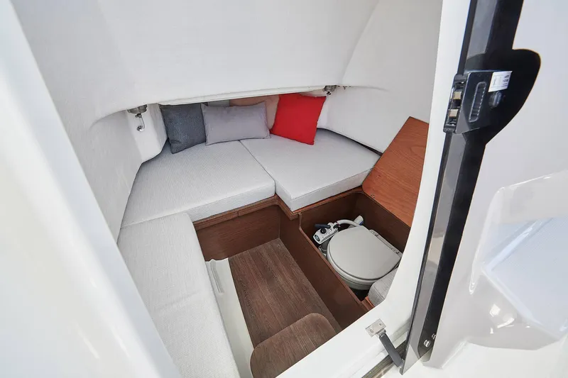 Slide: The Image of 2024 Jeanneau Leader 7.5 CC S3 boat cockpit with steering wheel and controls. - 13