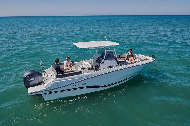 Slide: The Image of 2024 Jeanneau Leader 7.5 CC Series 3 boat displayed on stands outdoors. - 2