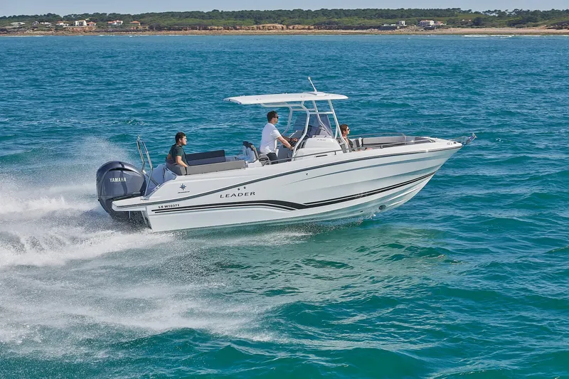 Slide: The Image of 2024 Jeanneau Leader 7.5 CC S3 boat with people enjoying a meal on deck. - 6