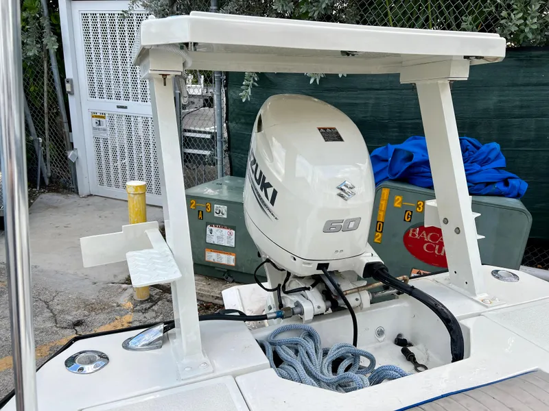 Slide: The Image of 1986 Hoog Comet 14 boat with Suzuki 60 outboard motor in a storage area. - 2