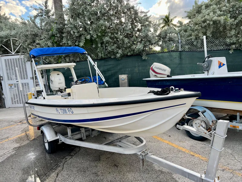 Slide: The Image of 1986 Hoog Comet 14 boat on trailer with blue canopy. - 4