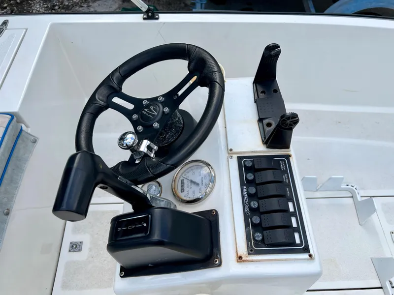 Slide: The Image of 1986 Hoog Comet 14 boat steering console with controls and gauges. - 6
