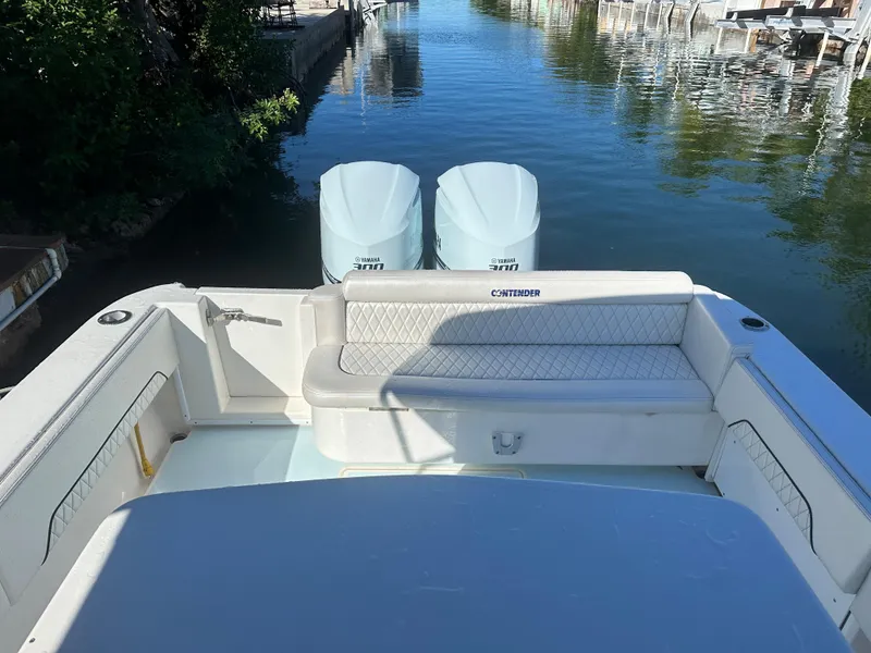 Slide: The Image of 2012 Contender 32 LS boat with twin engines docked in a canal. - 10