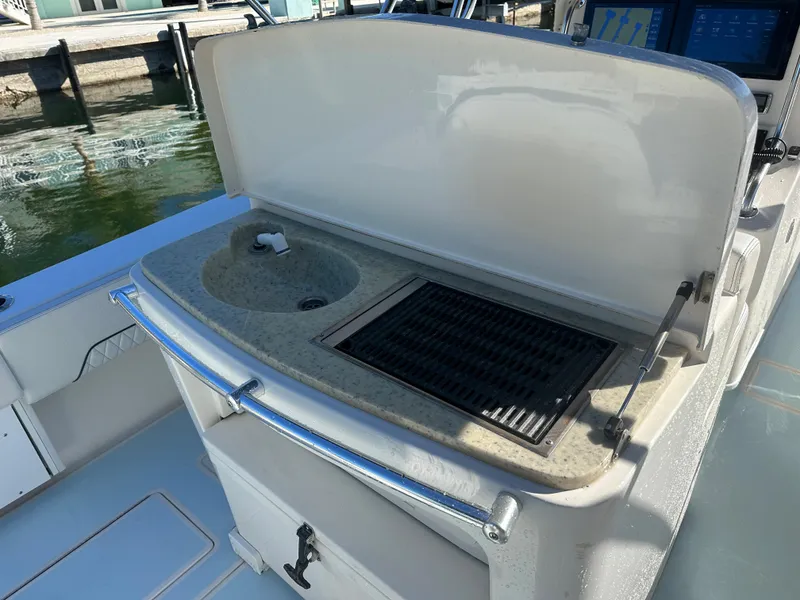 Slide: The Image of 2012 Contender 32 LS boat with onboard sink and grill station. - 13