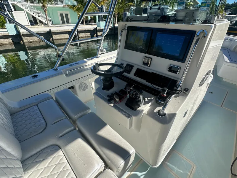 Slide: The Image of 2012 Contender 32 LS boat cockpit with dual screens and cushioned seating. - 14