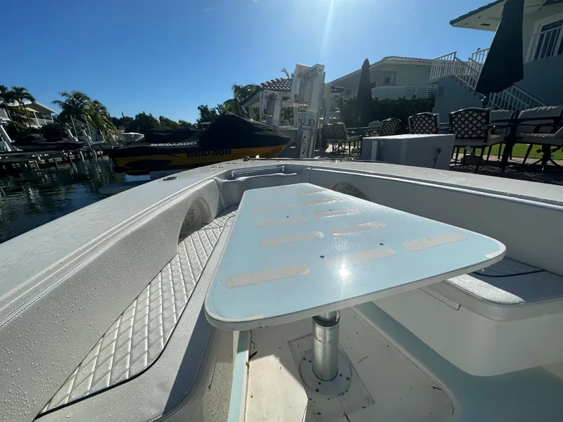 Slide: The Image of 2012 Contender 32 LS boat docked near waterfront homes. - 16