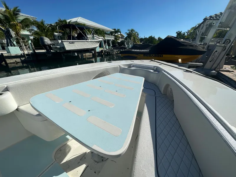 Slide: The Image of 2012 Contender 32 LS boat docked at a marina on a sunny day. - 17