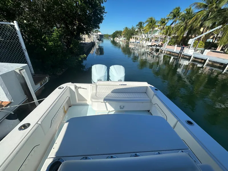 Slide: The Image of 2012 Contender 32 LS boat docked in a serene canal with palm trees. - 20