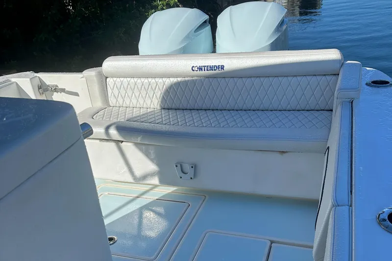 Slide: The Image of 2012 Contender 32 LS boat with cushioned seating and twin outboard motors. - 24