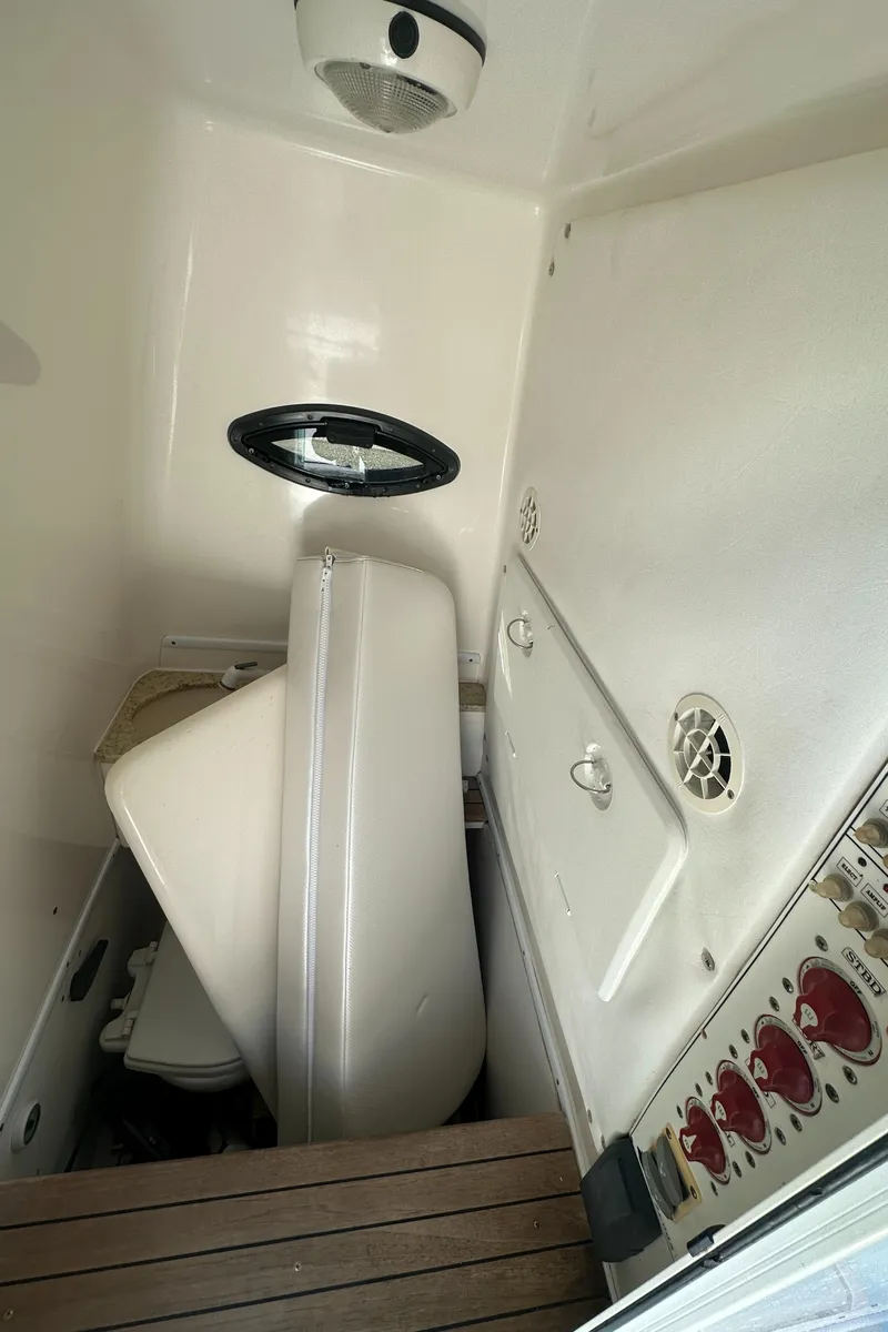 Slide: The Image of Interior of 2012 Contender 32 LS boat showing storage and control panel. - 26