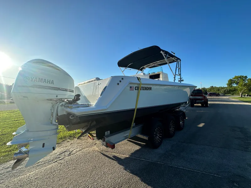 Slide: The Image of 2012 Contender 32 LS boat on trailer with Yamaha outboard engines. - 3
