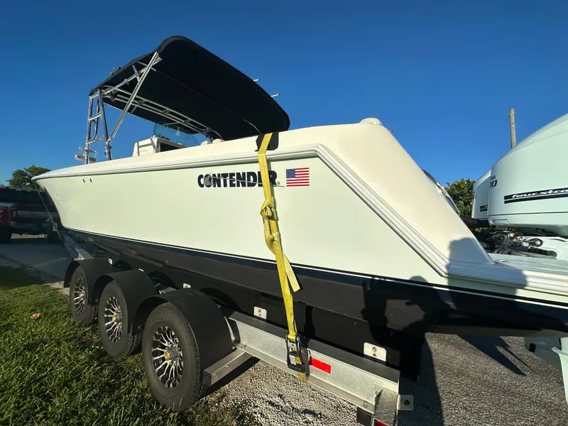 Slide: The Image of 2012 Contender 32 LS boat on a trailer, side view. - 7