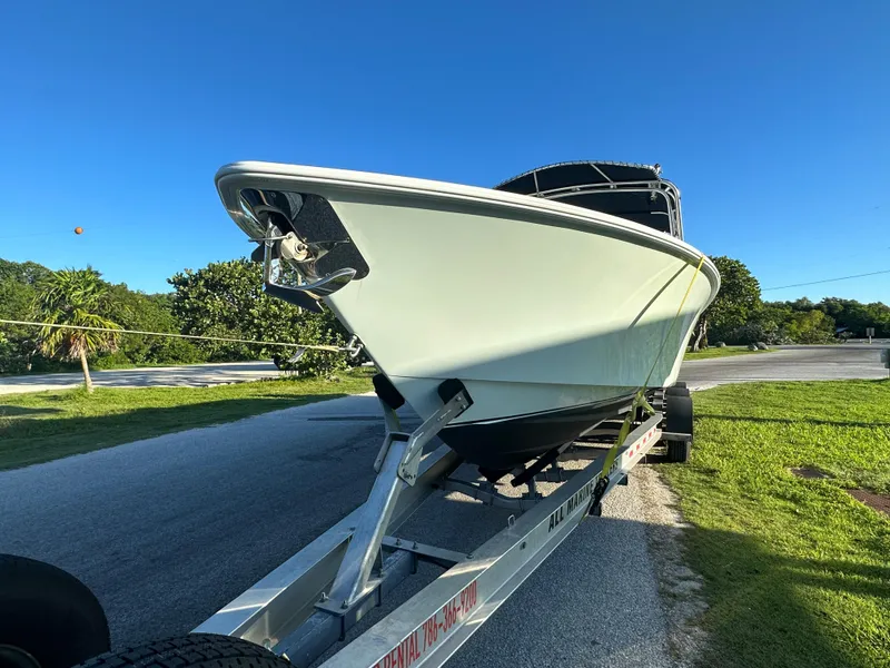 Slide: The Image of 2012 Contender 32 LS boat on trailer in sunny outdoor setting. - 8