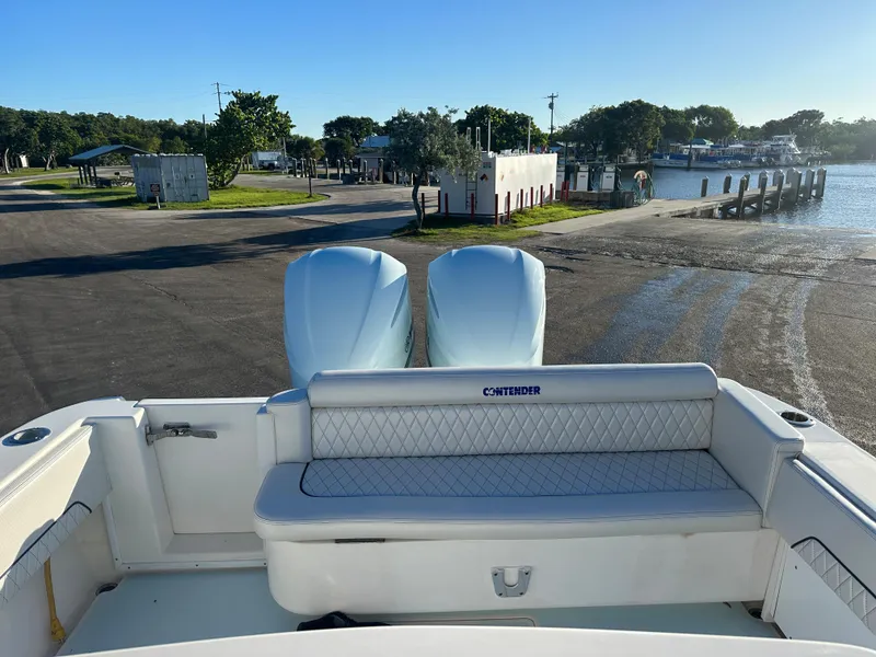 Slide: The Image of 2012 Contender 32 LS boat at a marina with twin engines. - 9
