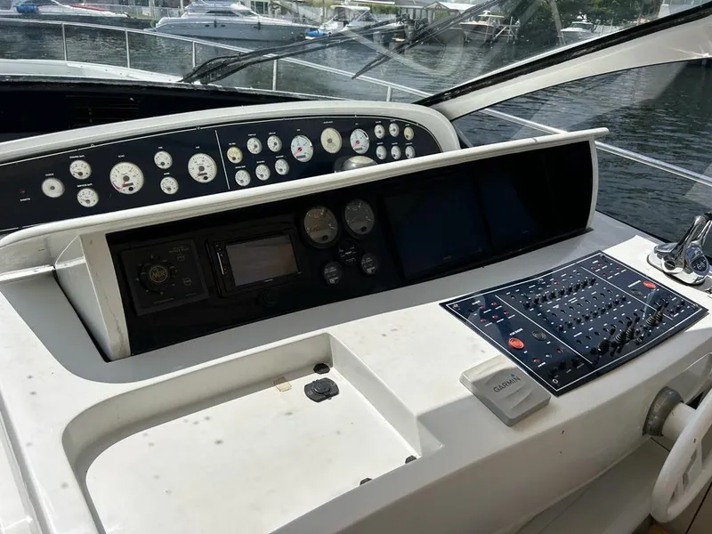 Slide: The Image of Control panel of a 1999 Pershing 54 yacht with various gauges and navigation equipment. - 1