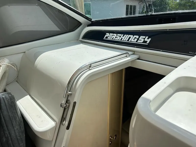 Slide: The Image of 1999 Pershing 54 yacht interior with cabin entrance and seating area. - 11