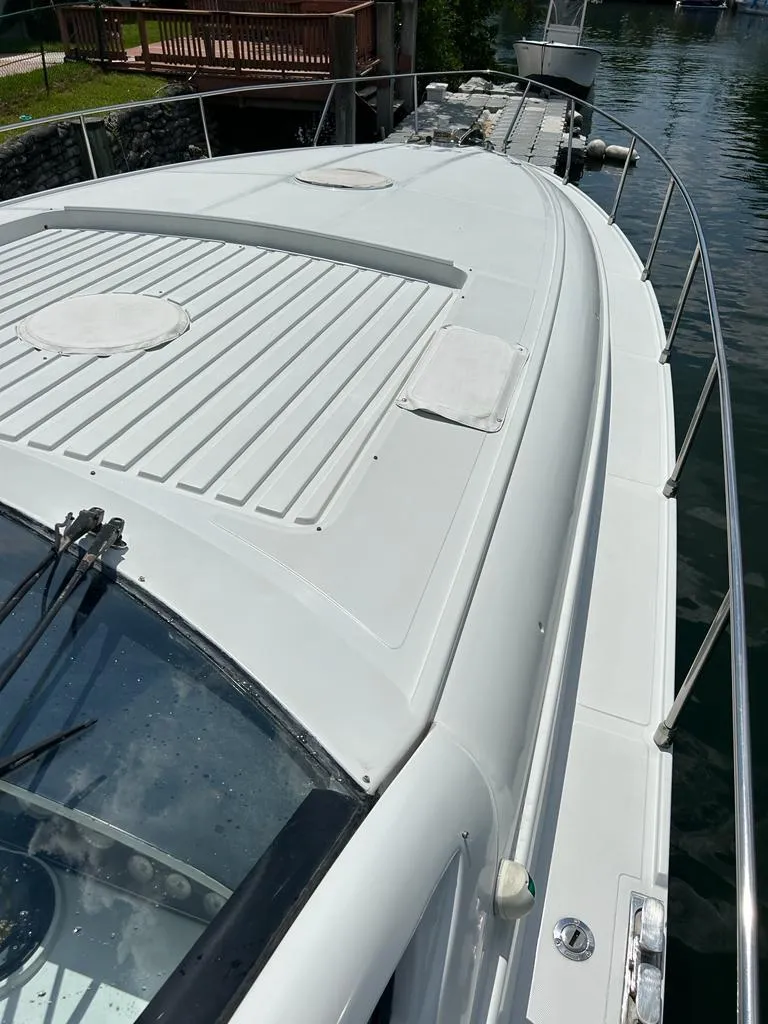 Slide: The Image of 1999 Pershing 54 yacht deck view, docked by the water. - 18