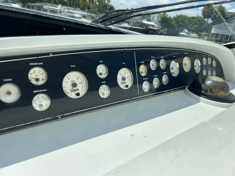 Slide: The Image of Dashboard of a 1999 Pershing 54 yacht with various gauges and instruments. - 2