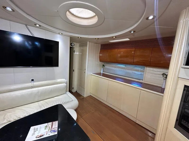 Slide: The Image of Luxurious interior of 1999 Pershing 54 yacht with modern furnishings and large TV. - 23