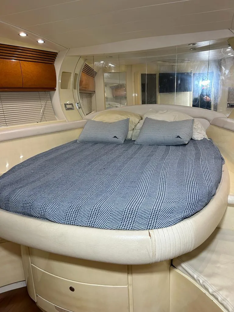 Slide: The Image of Luxurious bedroom interior of 1999 Pershing 54 yacht with cozy bedding. - 28