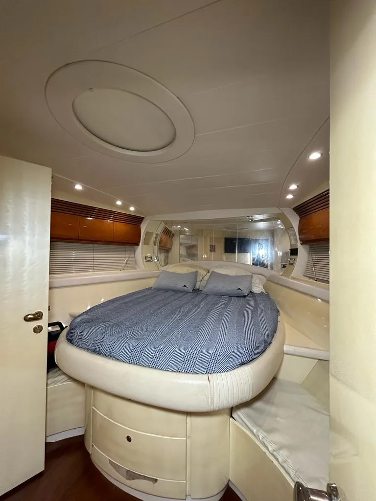 Slide: The Image of Luxurious bedroom interior of 1999 Pershing 54 yacht with circular bed and modern design. - 29