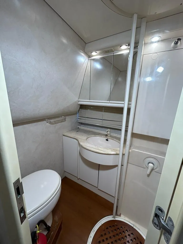 Slide: The Image of 1999 Pershing 54 yacht bathroom with sink, toilet, and shower. - 30