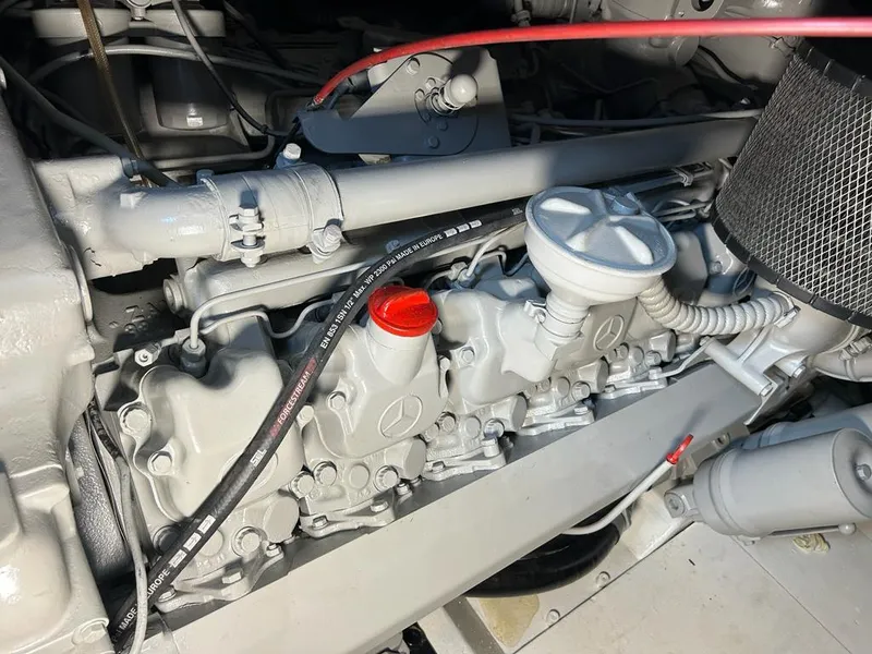 Slide: The Image of Engine compartment of a 1999 Pershing 54 yacht, showcasing detailed mechanical components. - 35