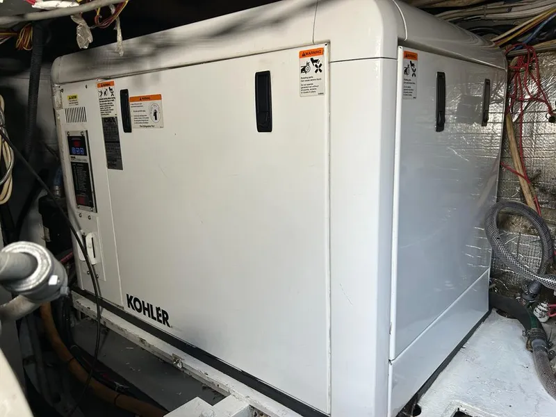 Slide: The Image of Kohler generator in the engine room of a 1999 Pershing 54 yacht. - 36