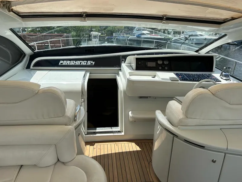 Slide: The Image of Interior of a 1999 Pershing 54 yacht with white leather seating and wooden flooring. - 4