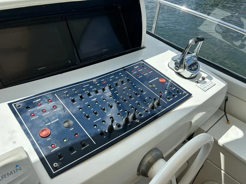 Slide: The Image of Control panel of a 1999 Pershing 54 yacht with navigation and throttle controls. - 5
