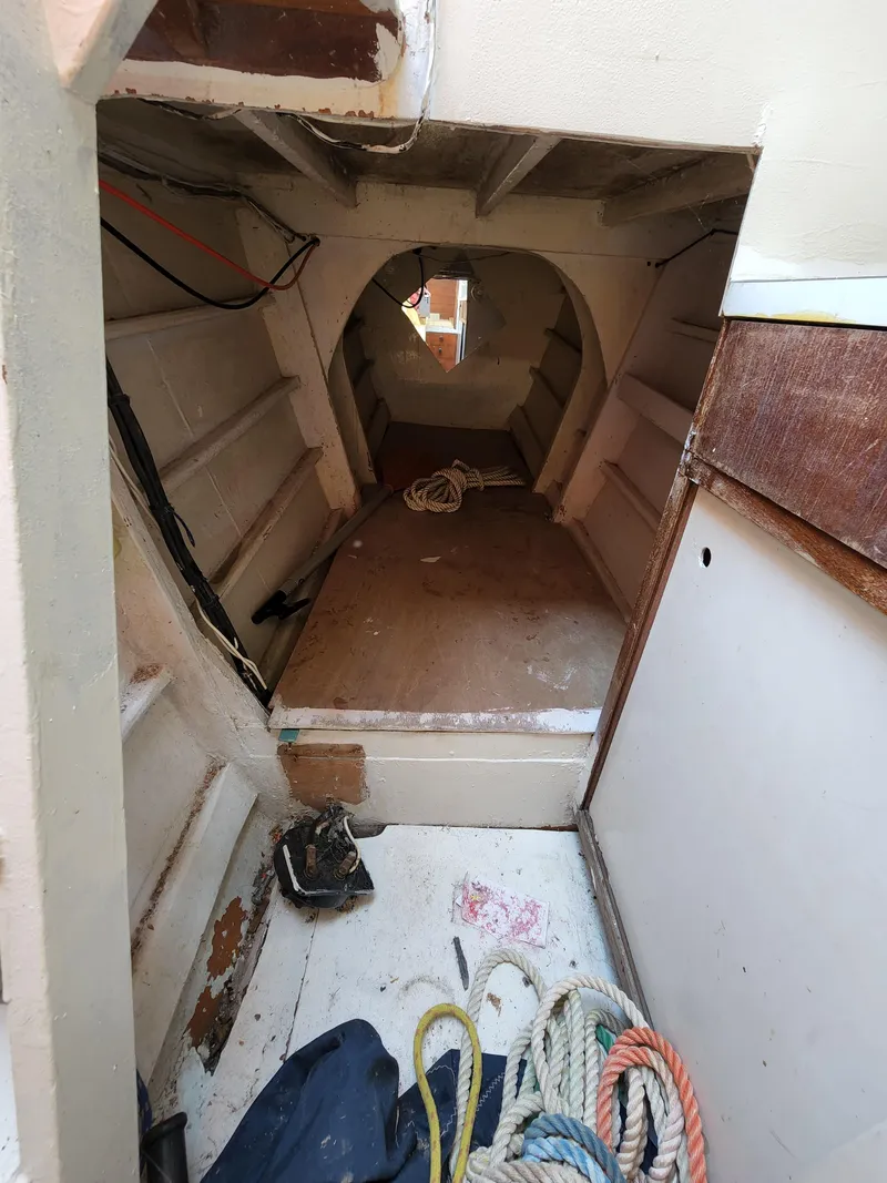 Slide: The Image of Interior of a 1985 Crowther Buccaneer boat showing storage space and ropes. - 11