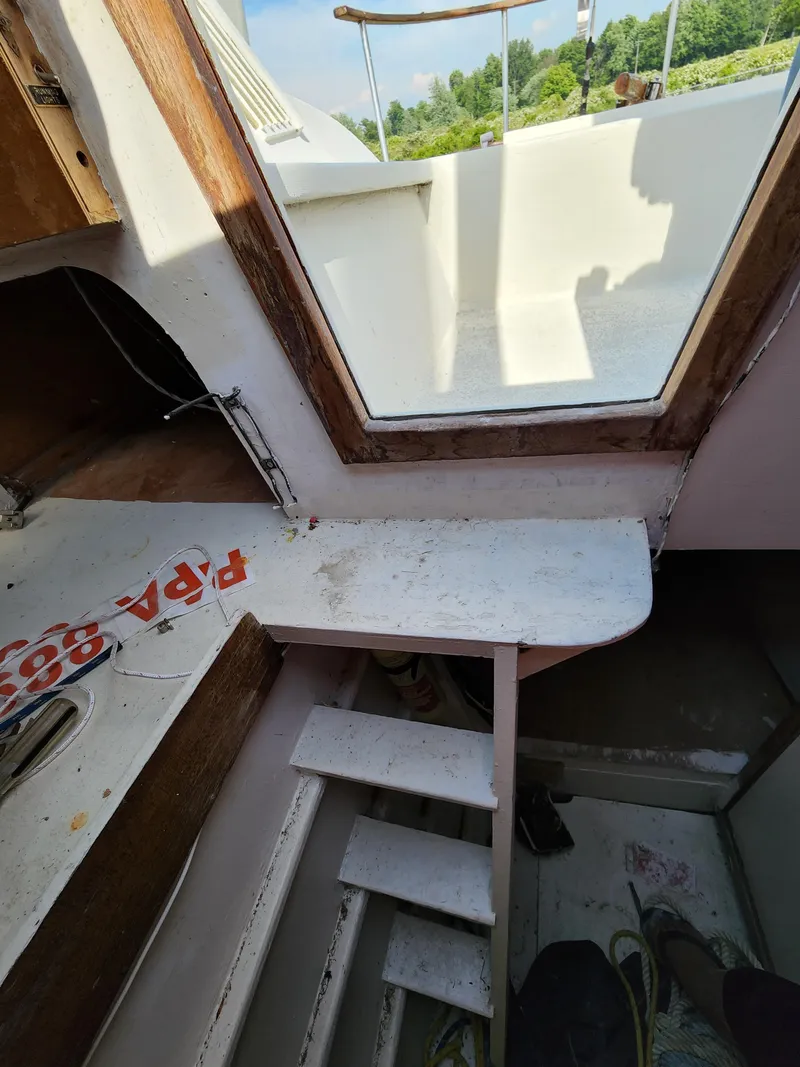 Slide: The Image of Interior view of a 1985 Crowther Buccaneer boat, featuring stairs and a window. - 13