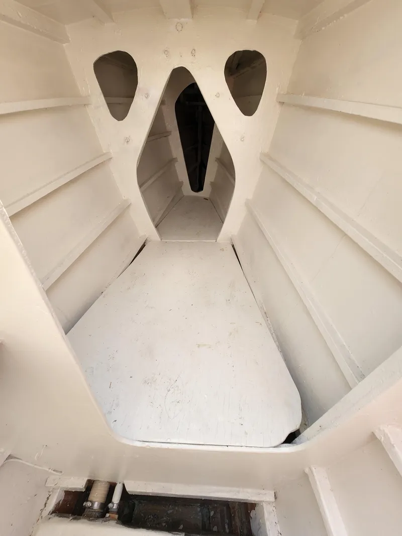 Slide: The Image of Interior view of 1985 Crowther Buccaneer boat, showcasing white cabin structure and design. - 14