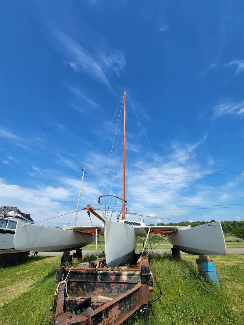 Slide: The Image of 1985 Crowther Buccaneer catamaran on trailer under clear blue sky. - 5
