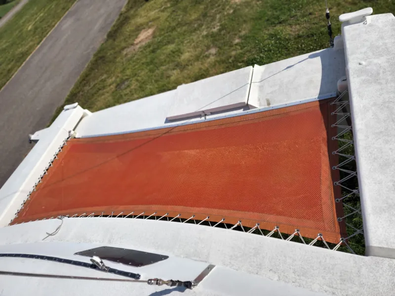 Slide: The Image of 1985 Crowther Buccaneer catamaran with orange netting and white deck, viewed from above. - 9