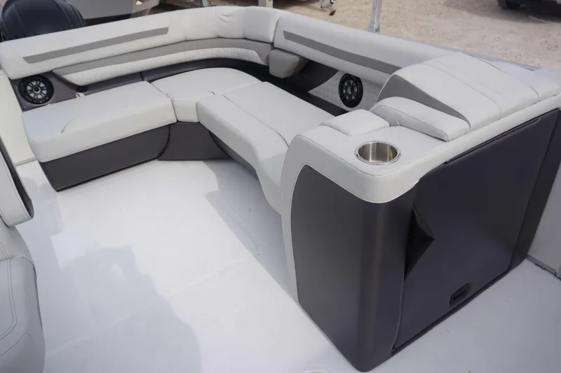 Slide: The Image of 2024 Hurricane FD 2360 RE3 boat interior with cushioned seating and cup holder. - 13