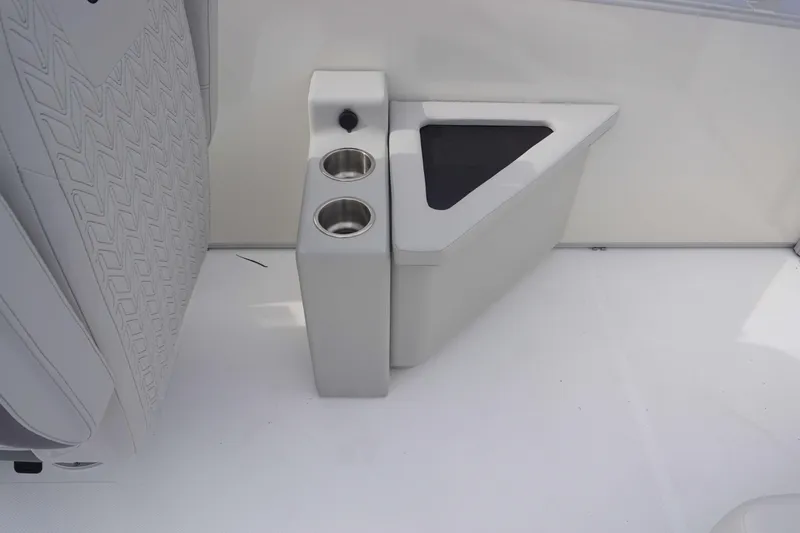 Slide: The Image of 2024 Hurricane FD 2360 RE3 boat interior with cup holders and storage compartment. - 14
